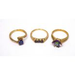 Three 9ct gold ladies' dress rings; one set with an oval blue stone,