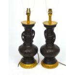 A pair of Chinese bronze temple vase table lamps, height 45cm.