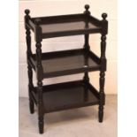 An Edwardian three-tier ebonised butler's table on turned supports, approx 98 x 59cm.