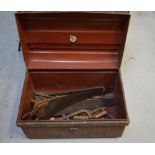 A metal chest with a quantity of vintage tools to include saws,