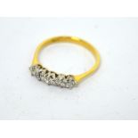 An 18ct gold ring with five graduating diamonds, size P, approx 2.1g.