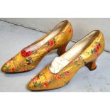 A pair of c1920s gold kid shoes with printed floral decoration and shaped sparkle-effect heels.