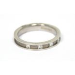 An 18ct white gold channel-set five princess-cut diamond ring with brushed metal detailing, size M,