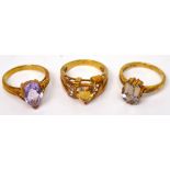 A 9ct gold dress ring with heart-shaped amber stone and three small white stones set to shoulders,