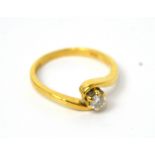 An 18ct yellow gold solitaire diamond ring in cross-over setting, size K 1/2, approx 2.9g.