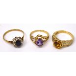 Three 9ct gold ladies' dress rings; one floral-set with central blue stone and white stone surround,