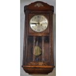 A 20th century oak-cased wall clock with glazed panels, height 77cm.