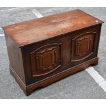 A dark oak carved blanket box, length 93cm.