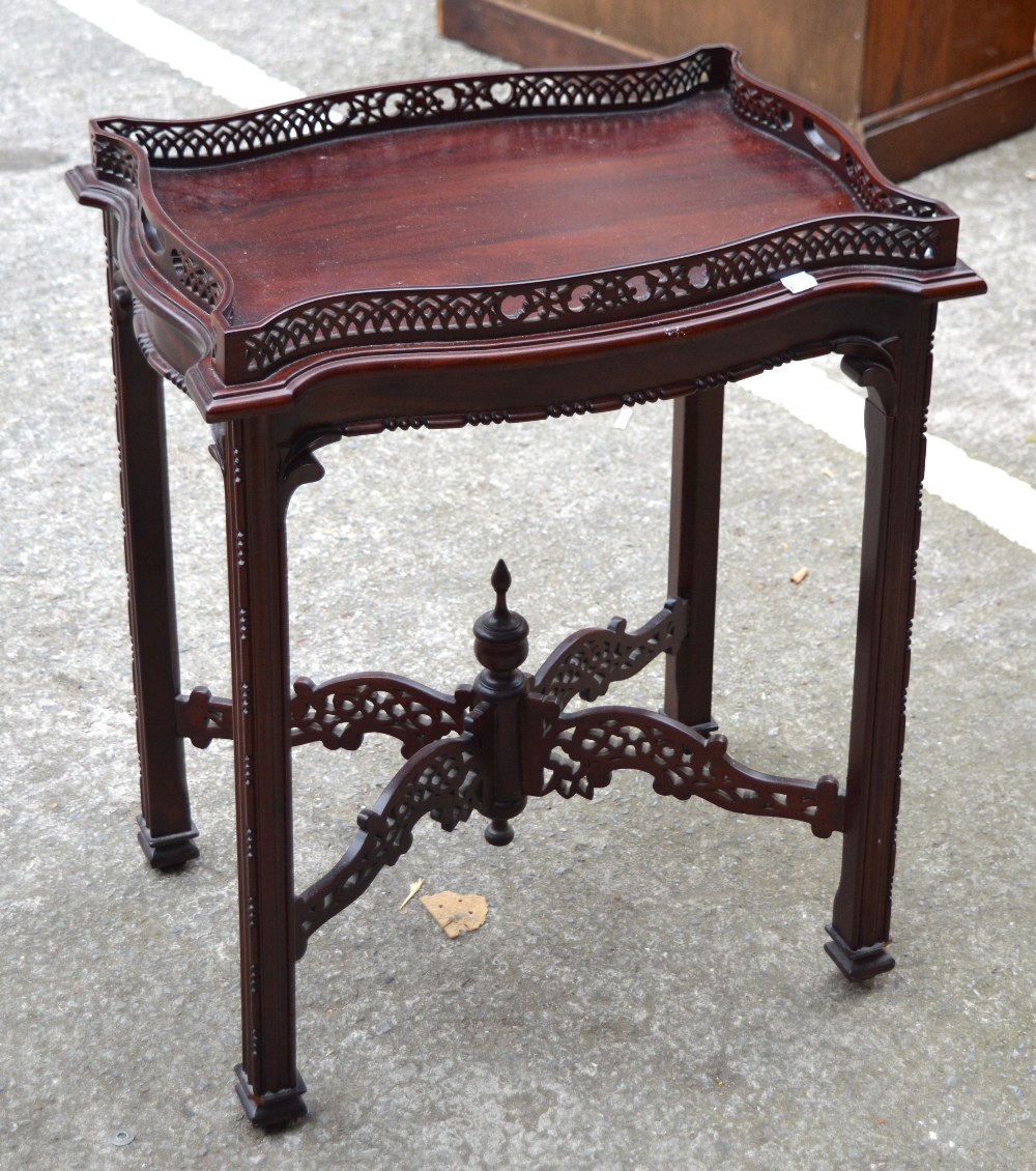 A reproduction mahogany butler's tray with pierced frieze edging and four pierced central