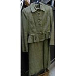 A 1970s Christian Dior green wool suit, with A-line dress and peplum waist to the jacket.