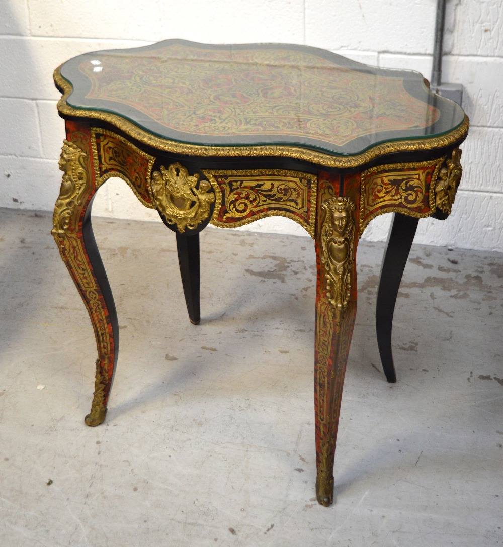 A French boule work ormolu-mounted occasional table with faux tortoiseshell inlay and cherub and