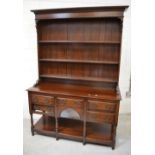 A reproduction oak dresser, the boarded plate rack above a five-drawer base with potboard undertier,