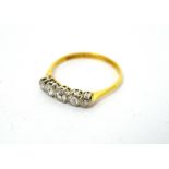 An 18ct gold ring with five graduating diamonds, size N 1/2, approx 1.7g.