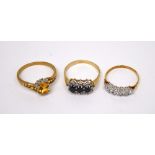 Three 9ct gold ladies' dress rings; one set with three rows of white stones,