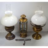 Two brass oil lamps and a brass decorative storm lantern (3).