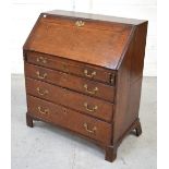 An early 19th century oak bureau,