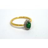 A 9ct yellow gold oval-cut emerald ring surrounded by melee diamonds, size L 1/2, approx 1.6g.