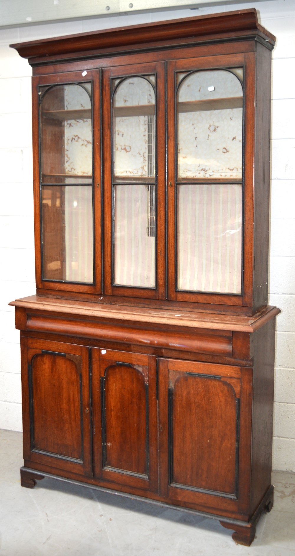 A Victorian bookcase, top section with two glazed doors and central glazed panel,