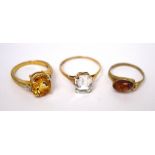 Three 9ct gold ladies' dress rings; one set with clear emerald stone, size T,