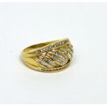 A 9ct yellow gold fancy slanted ring set with slanted baguette-cut diamonds and channel-set melee