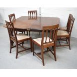 An Edwardian mahogany dining table on tapering reeded baluster supports to peg feet with castors,