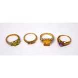 Four 9ct gold ladies' dress rings to include one set with large amber-coloured stone and small