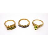 Three 9ct gold ladies' dress rings; one example set with three green stones, size M,