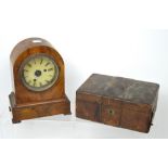 A c1930s walnut dome-top clock case, enamel dial set with Roman numerals,