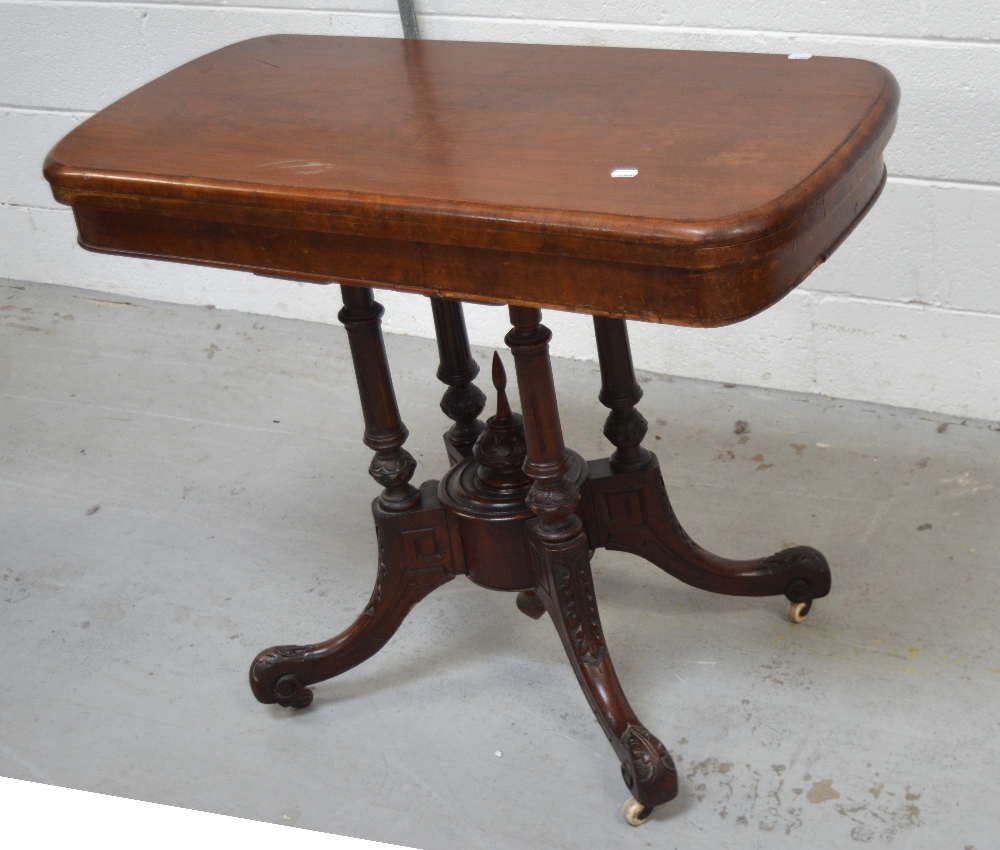 A 19th century mahogany fold-over games table on turned tapering supports to quatrefoil carves base, - Image 2 of 2