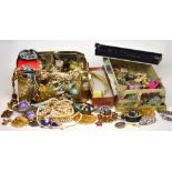 A large quantity of costume jewellery to include faux pearls, clip earrings,