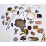 A quantity of vintage costume jewellery to include a mother of pearl bangle with white metal dog's