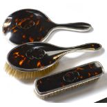 A George V hallmarked silver faux tortoiseshell and silver pique work dressing table set to include