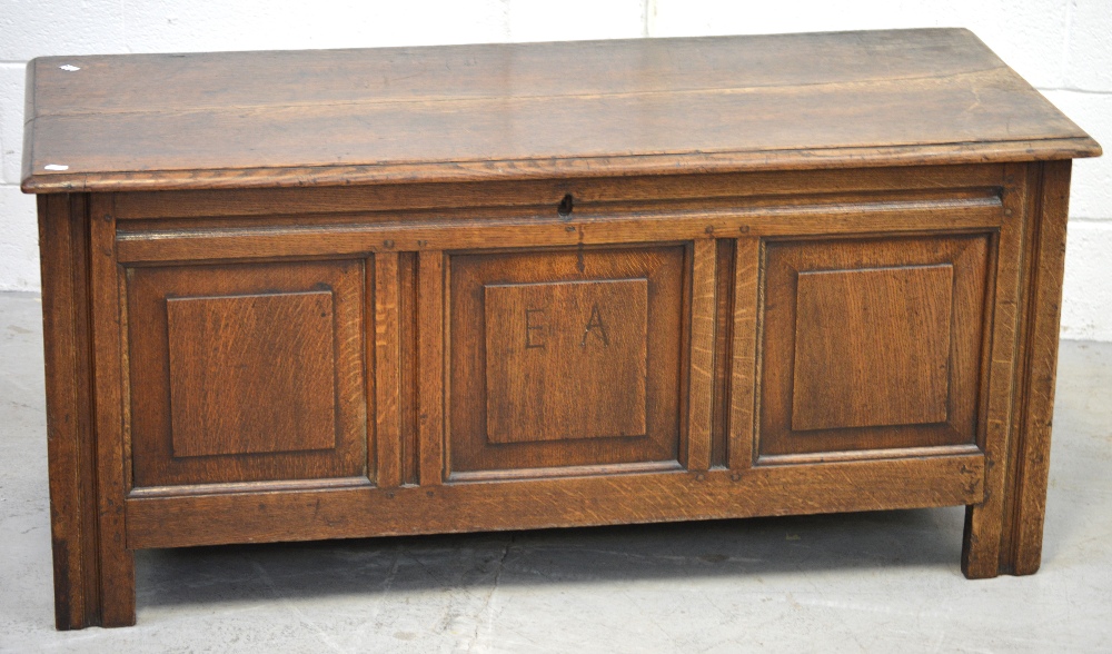 A late 19th century oak coffer with three front panels,