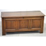 A late 19th century oak coffer with three front panels,