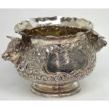 A plated trophy bowl with floral repoussé decoration and cow's head decoration to either side,
