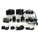 A quantity of cameras and lenses to include a Zenit camera, Olympus cameras,