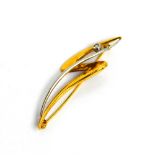 A 9ct white and yellow gold, David Robinson, contemporary brooch set with a single diamond.