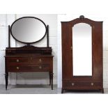 An Edwardian mahogany single glazed door wardrobe with circular and band inlay,
