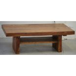 A contemporary hardwood coffee table with lower shelf on block supports, length 117cm.