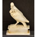 A soapstone carved dove of peace holding an olive branch, height 23cm (af).