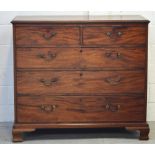 A late 19th early 20th century mahogany two-over-three chest of drawers on stepped supports,