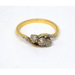 An 18ct yellow gold and platinum brilliant-set three-stone diamond platinum-mounted crossover ring,