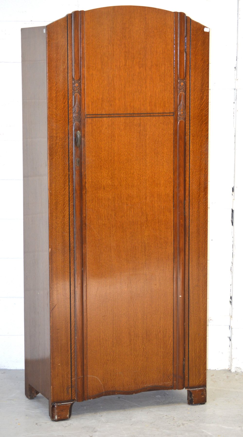 A mid-20th century oak single-door hall robe on bracket supports, 180cm.