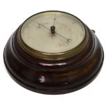 A circular mahogany-cased barometer with silvered dial, diameter 29cm.