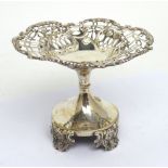 A George V hallmarked silver filigree dish on pedestal base and raised supports,