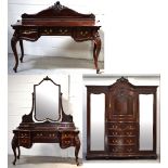 An Edwardian mahogany Waring & Gillow bedroom suite comprising a wardrobe with central carved