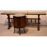 A contemporary oak long side/serving table with central carved baluster decoration to stepped