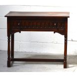A 20th century carved oak hall table with long drawer, turned front legs leading to stretchers,