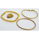 Two 9ct gold bangles, a yellow metal heart pendant marked 9ct, approx combined 12.