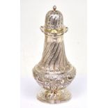 A Victorian hallmarked silver sugar sifter with floral and scrolling repoussé decoration,